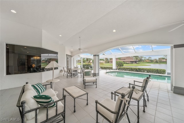 view of patio / terrace featuring a water view and ceiling fan