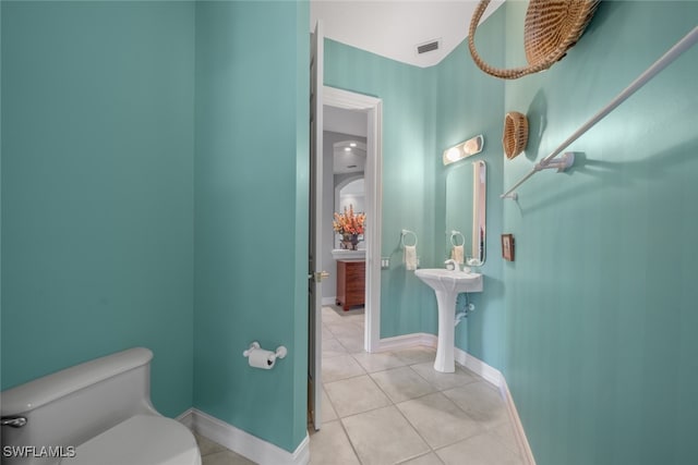 bathroom featuring tile patterned flooring and toilet