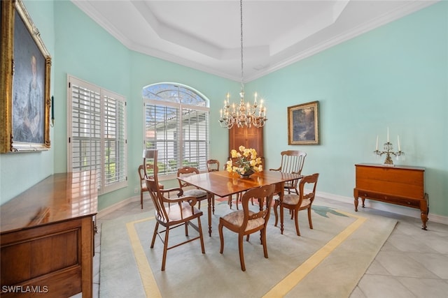 tiled dining room with a chandelier, crown molding, and a raised ceiling