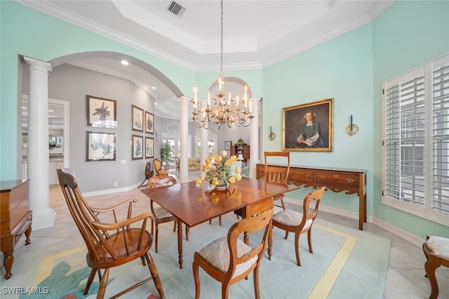 dining area with light tile patterned flooring, a notable chandelier, crown molding, and decorative columns