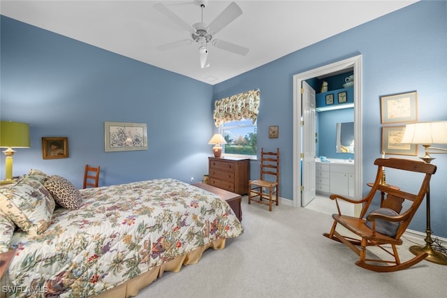 bedroom with ceiling fan, connected bathroom, and light carpet