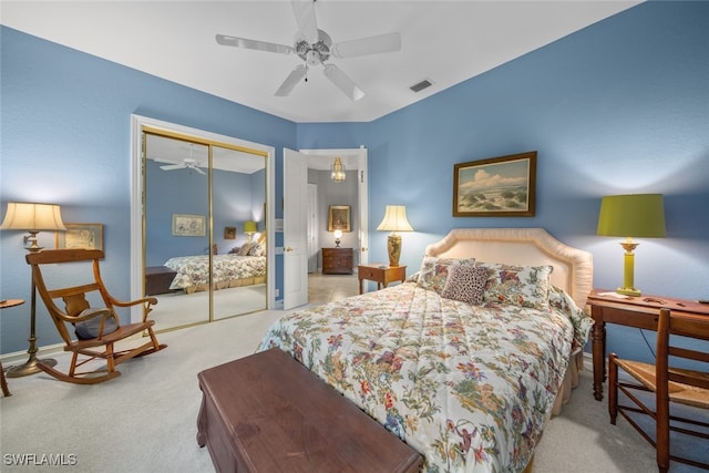 carpeted bedroom featuring ceiling fan and a closet