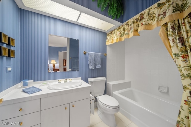 bathroom with toilet, vanity, tile patterned flooring, and a bathing tub