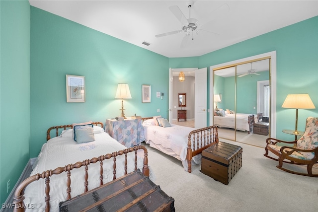 bedroom with ceiling fan, carpet flooring, and a closet