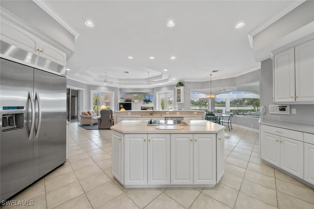 kitchen featuring white cabinetry, built in fridge, and a center island