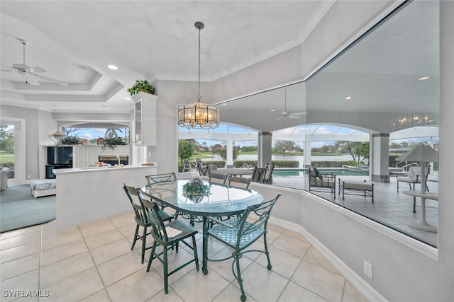 tiled dining room featuring plenty of natural light and crown molding