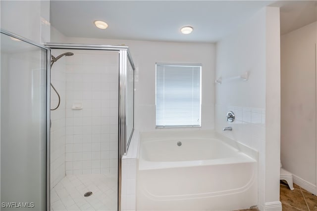 bathroom featuring plus walk in shower and tile patterned flooring