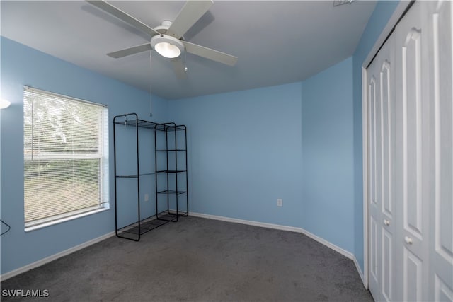 unfurnished bedroom featuring ceiling fan, a closet, and carpet