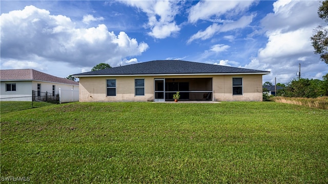 back of house featuring a lawn