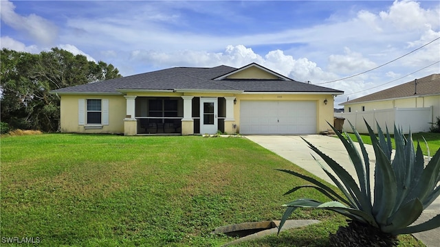 view of front of property featuring a front lawn and a garage