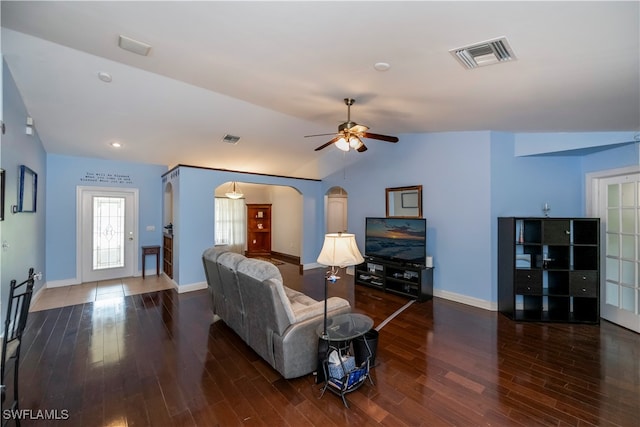 living room featuring dark hardwood / wood-style flooring, vaulted ceiling, and ceiling fan