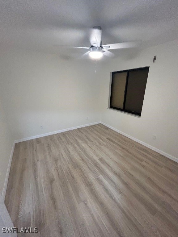 spare room with light hardwood / wood-style floors, ceiling fan, and a textured ceiling