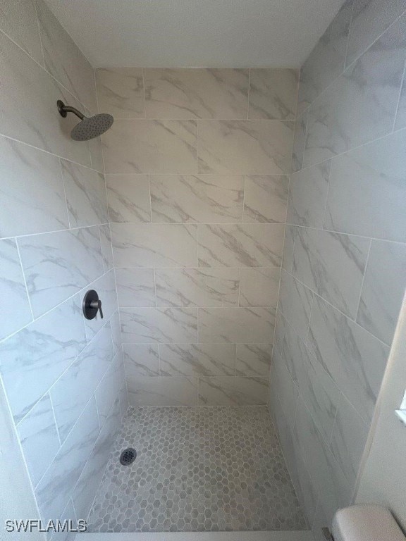 bathroom with a tile shower