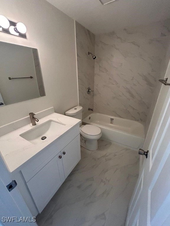 full bathroom with vanity, toilet, and tiled shower / bath