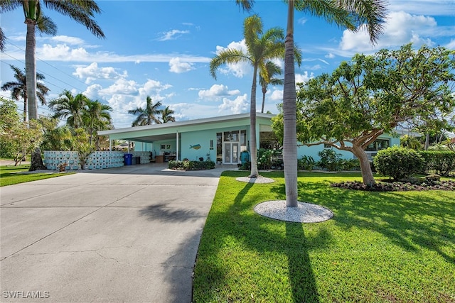 single story home with a front lawn and a carport