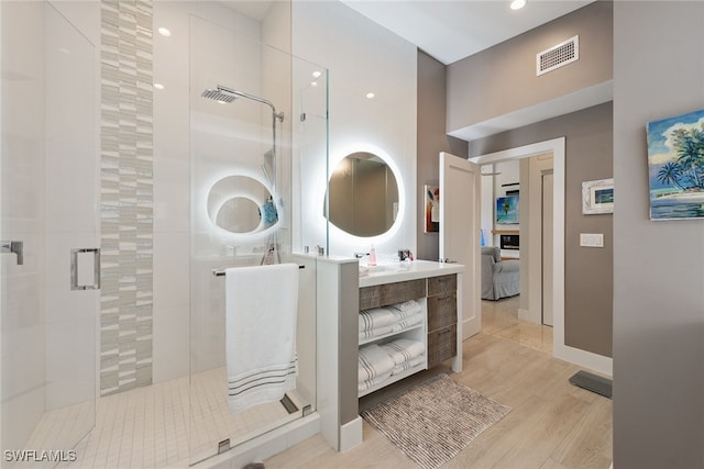 bathroom with vanity, wood-type flooring, and walk in shower