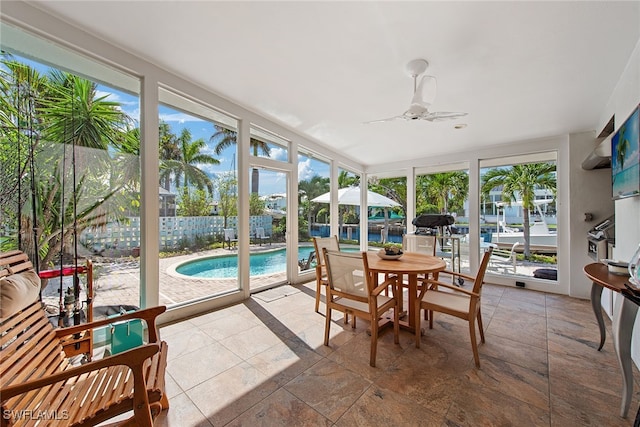 sunroom featuring ceiling fan