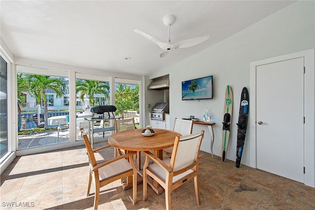 dining area featuring ceiling fan and lofted ceiling