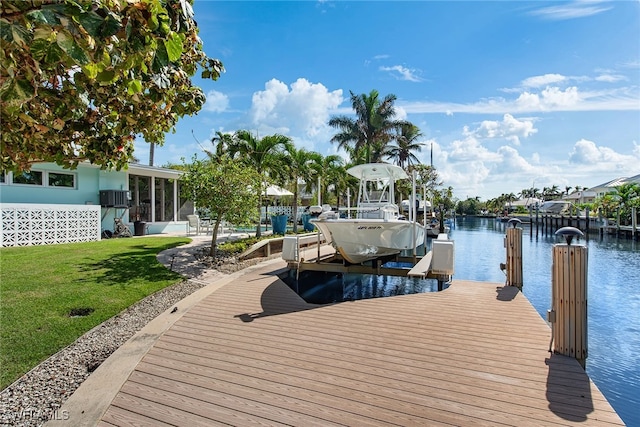 view of dock featuring a lawn and a water view