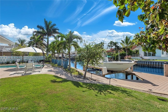 dock area featuring a lawn and a water view