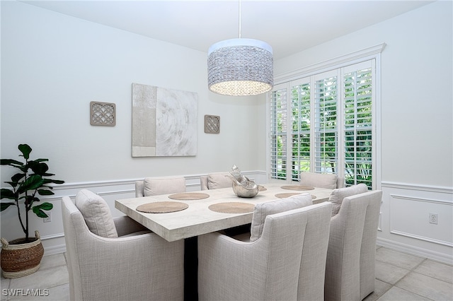 tiled dining space with a notable chandelier