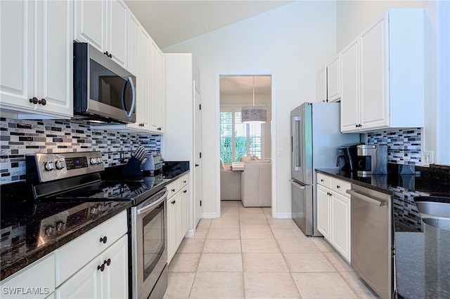 kitchen with white cabinets, dark stone counters, and appliances with stainless steel finishes