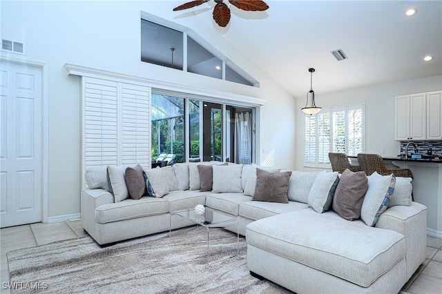 tiled living room featuring high vaulted ceiling and ceiling fan