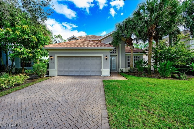 view of front of home featuring a garage and a front lawn