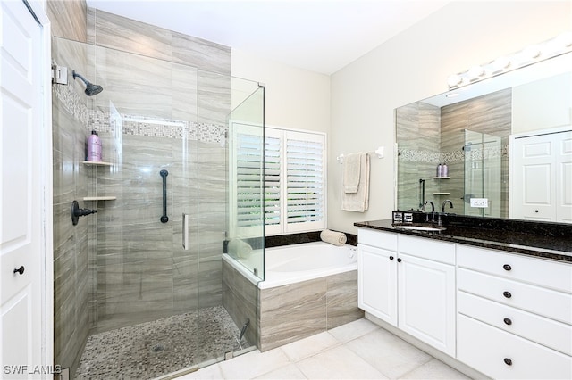 bathroom with tile patterned flooring, vanity, and independent shower and bath