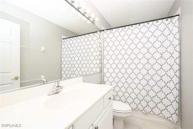 bathroom featuring toilet, vanity, and tile patterned floors