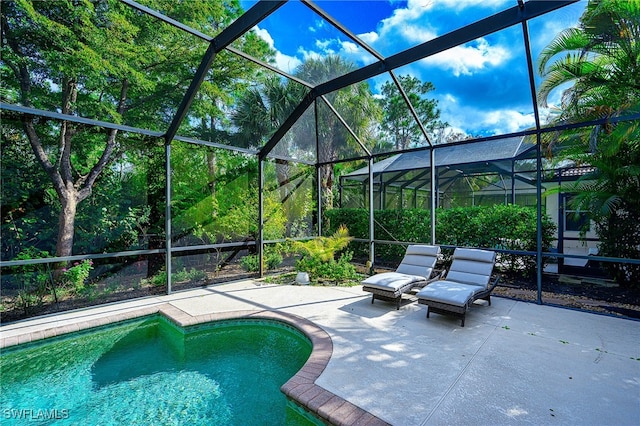 view of pool with a lanai and a patio area