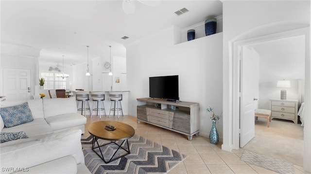 tiled living room with a chandelier