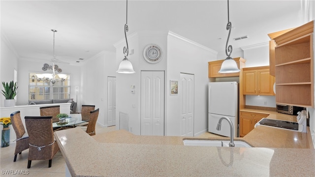 kitchen featuring sink, light tile patterned floors, an inviting chandelier, crown molding, and white refrigerator