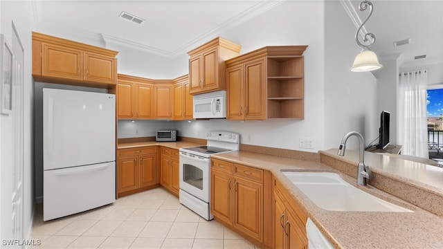 kitchen with white appliances, sink, pendant lighting, and crown molding