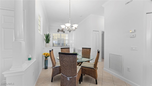 dining area featuring ornamental molding, a chandelier, and light tile patterned floors