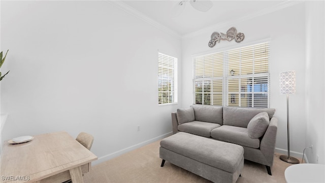 sitting room with light colored carpet, ceiling fan, and crown molding