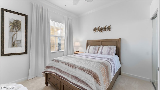 carpeted bedroom featuring ceiling fan, a closet, and crown molding