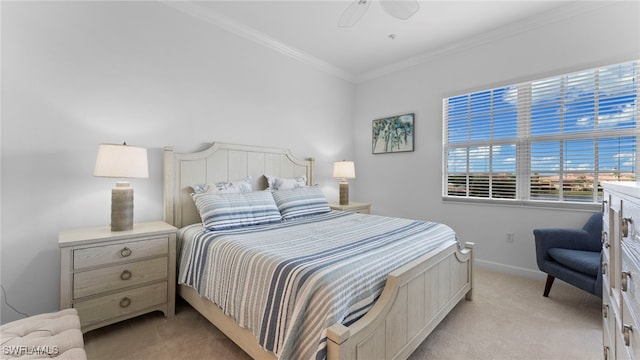 bedroom with light colored carpet, ceiling fan, and crown molding