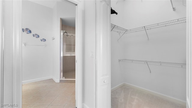 walk in closet featuring light tile patterned floors