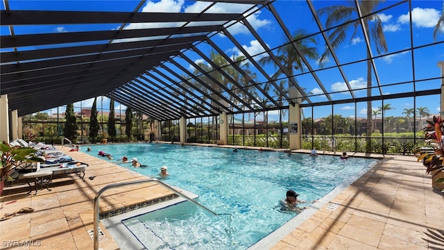 view of swimming pool featuring a lanai and a patio