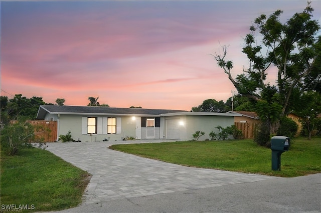 ranch-style house featuring a lawn