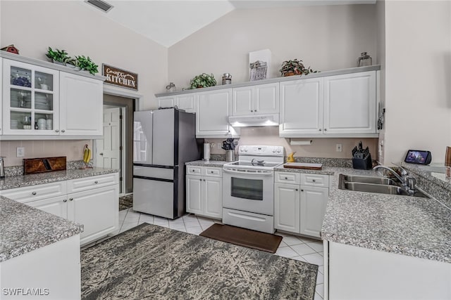 kitchen with sink, light tile patterned flooring, white cabinetry, white electric stove, and stainless steel fridge