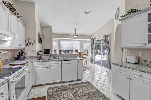 kitchen with white appliances, white cabinetry, sink, and decorative backsplash