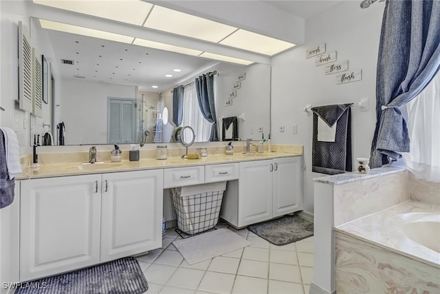 bathroom with vanity, tile patterned floors, and plus walk in shower