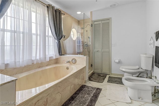 bathroom featuring a bidet, tile patterned floors, toilet, a washtub, and vanity