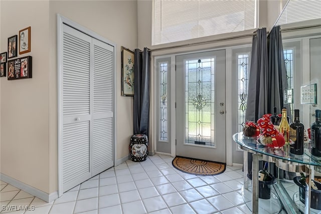 tiled entrance foyer with a healthy amount of sunlight