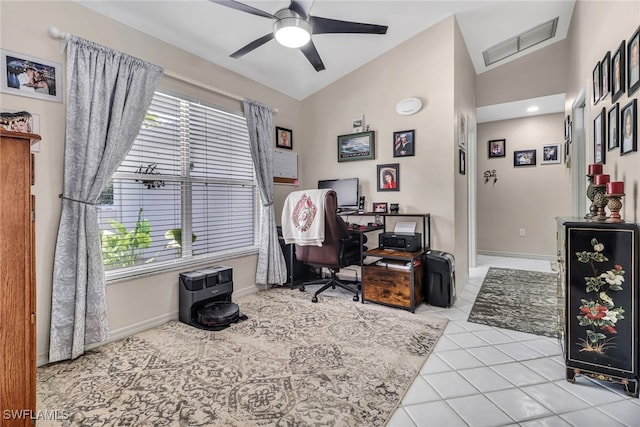 home office with ceiling fan, light tile patterned floors, and lofted ceiling