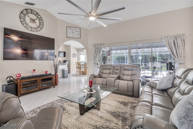 living room with ceiling fan, light tile patterned floors, and high vaulted ceiling