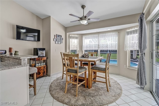 603 Canton Ave, Lehigh Acres, FL 33972 - dining space with light tile patterned floors, ceiling fan, and baseboards