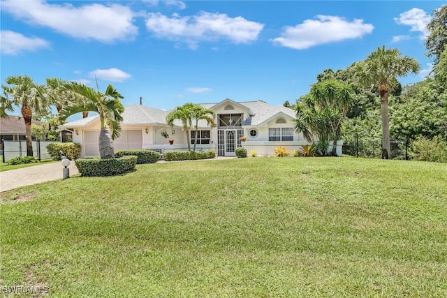 single story home with a garage and a front yard